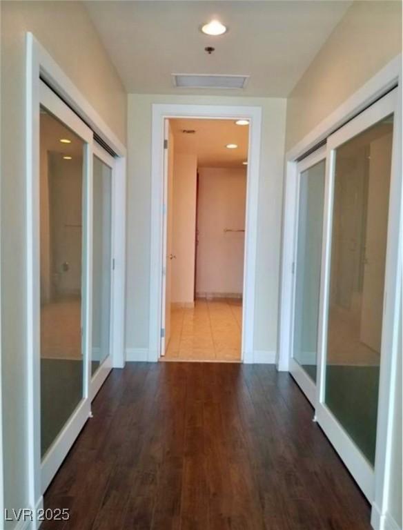 hallway with recessed lighting, baseboards, and wood finished floors