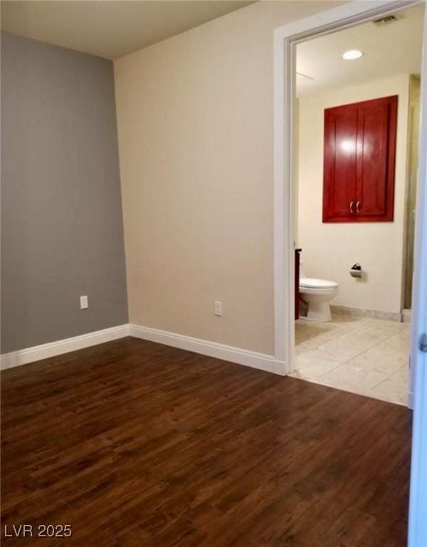 interior space with visible vents, baseboards, and wood finished floors