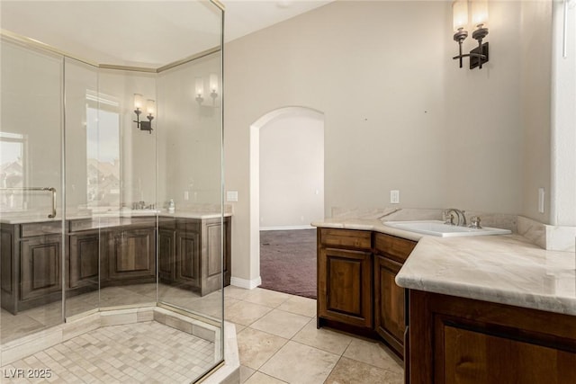 full bathroom with baseboards, vanity, a shower with door, and tile patterned floors