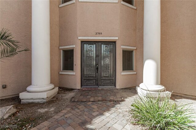 doorway to property with stucco siding