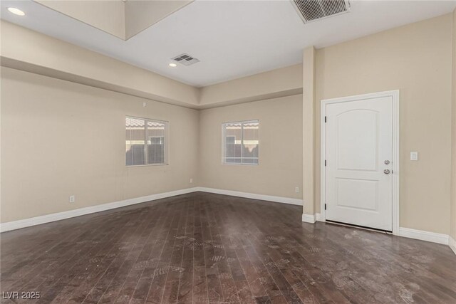 spare room featuring recessed lighting, wood finished floors, visible vents, and baseboards