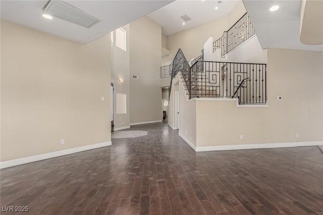 entryway featuring stairs, wood finished floors, and baseboards