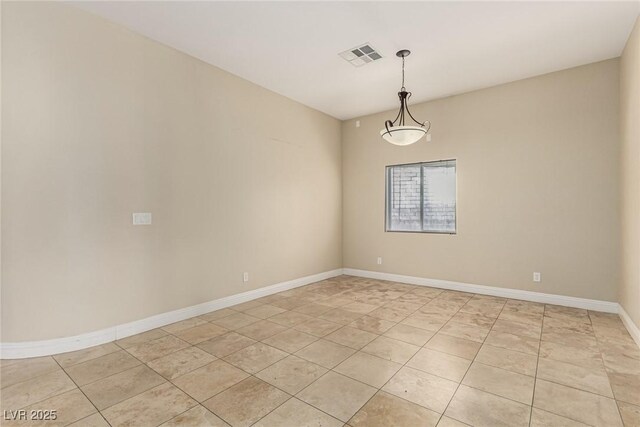 unfurnished room with visible vents, baseboards, and light tile patterned floors