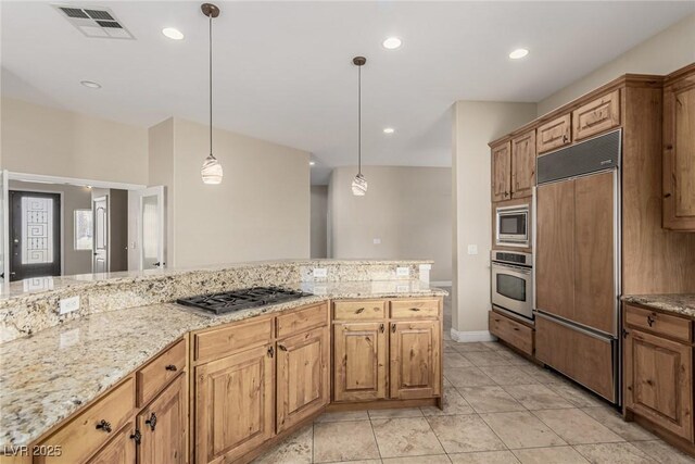 kitchen featuring visible vents, decorative light fixtures, built in appliances, light stone countertops, and recessed lighting