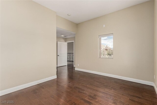 empty room with baseboards and dark wood-style flooring