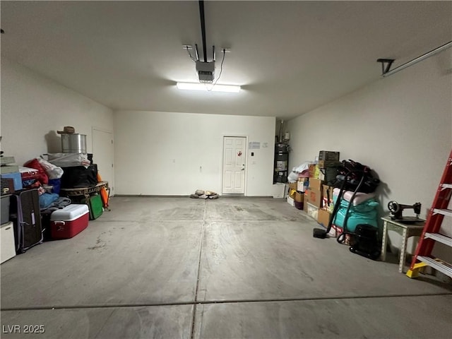 garage featuring strapped water heater and a garage door opener