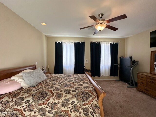 bedroom featuring visible vents, multiple windows, carpet flooring, and a ceiling fan