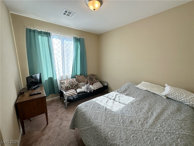 carpeted bedroom featuring visible vents