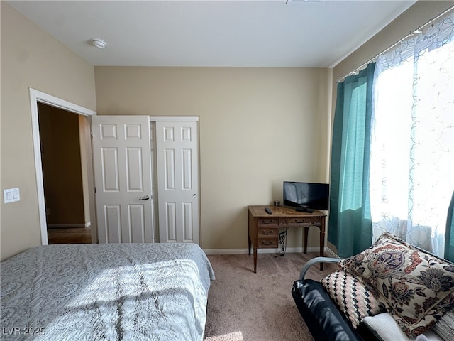 bedroom featuring carpet floors and baseboards