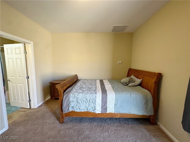 carpeted bedroom with visible vents and baseboards