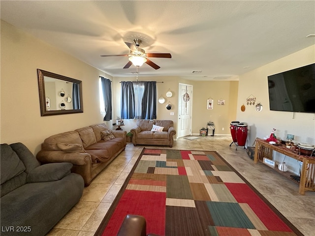 living room featuring light tile patterned floors, ceiling fan, and visible vents