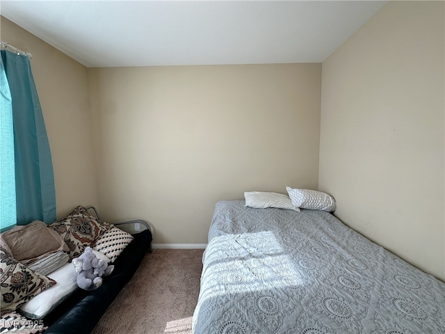 carpeted bedroom featuring baseboards