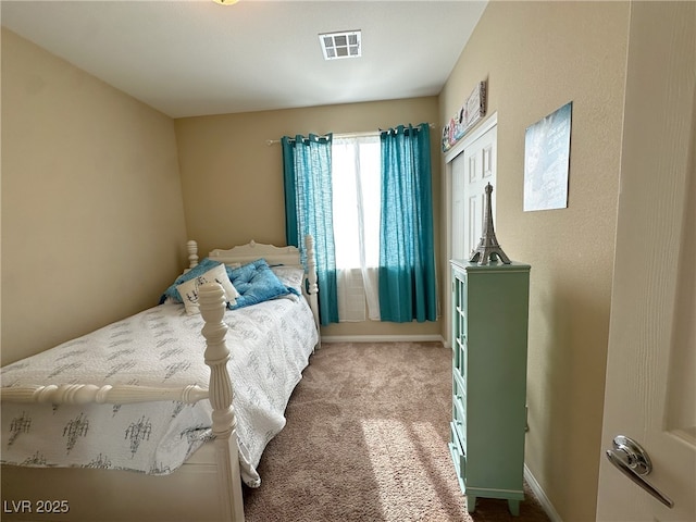 bedroom with carpet, visible vents, and baseboards