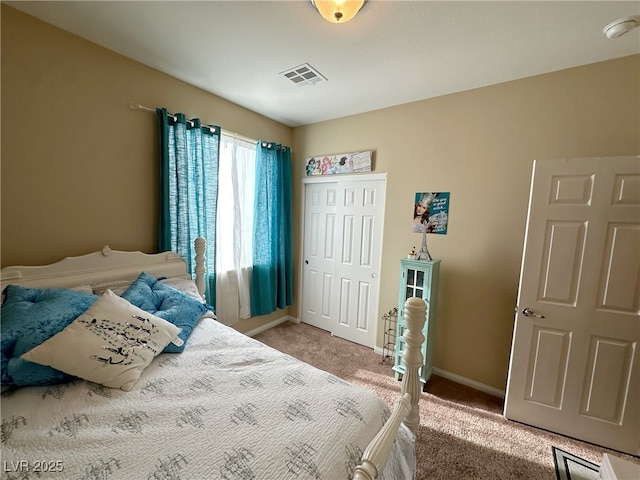 bedroom with visible vents, baseboards, a closet, and light colored carpet