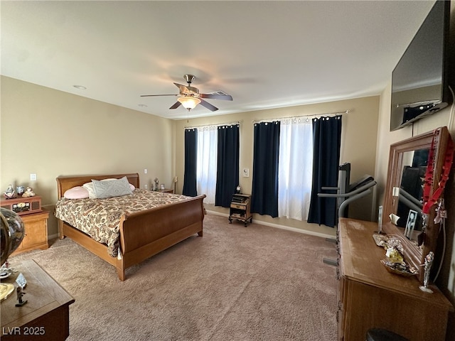 carpeted bedroom featuring baseboards and a ceiling fan