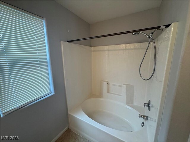 full bathroom featuring tile patterned flooring, baseboards, and bathtub / shower combination