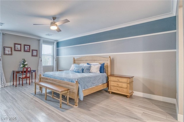 bedroom with light wood-type flooring, visible vents, crown molding, and baseboards