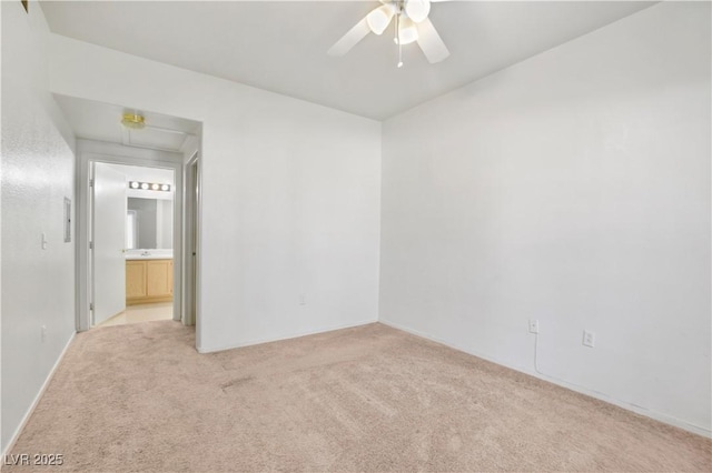 unfurnished room featuring light colored carpet and ceiling fan