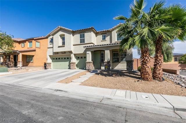 mediterranean / spanish-style house featuring a garage, driveway, stone siding, a tile roof, and stucco siding