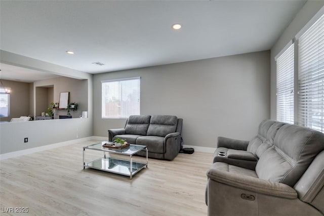 living room with a chandelier, recessed lighting, visible vents, baseboards, and light wood-style floors