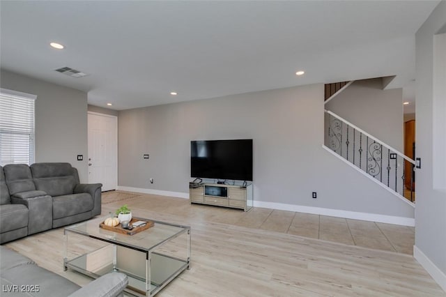 living area with stairs, recessed lighting, wood finished floors, and baseboards