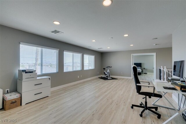 home office with light wood-style floors, baseboards, visible vents, and recessed lighting