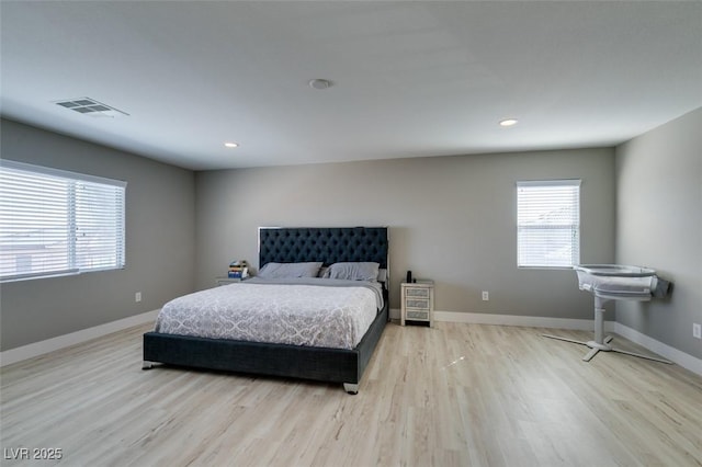 bedroom with baseboards, visible vents, wood finished floors, and recessed lighting