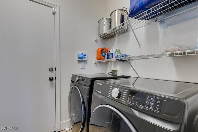 clothes washing area featuring laundry area and washer and clothes dryer