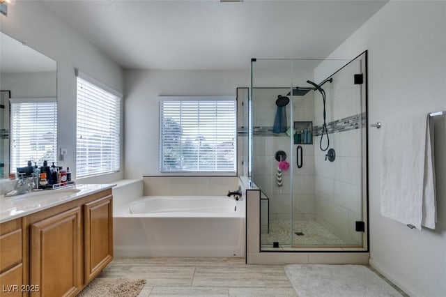 bathroom featuring vanity, a shower stall, and a bath