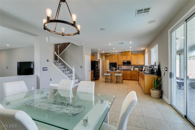 dining space featuring light tile patterned floors, visible vents, stairway, a chandelier, and recessed lighting