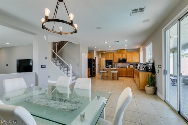dining space with light tile patterned floors, stairs, a chandelier, recessed lighting, and baseboards