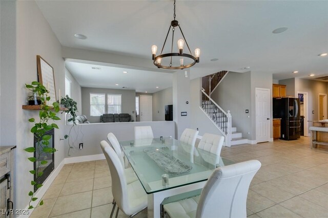 dining room featuring recessed lighting, light tile patterned floors, baseboards, and stairs