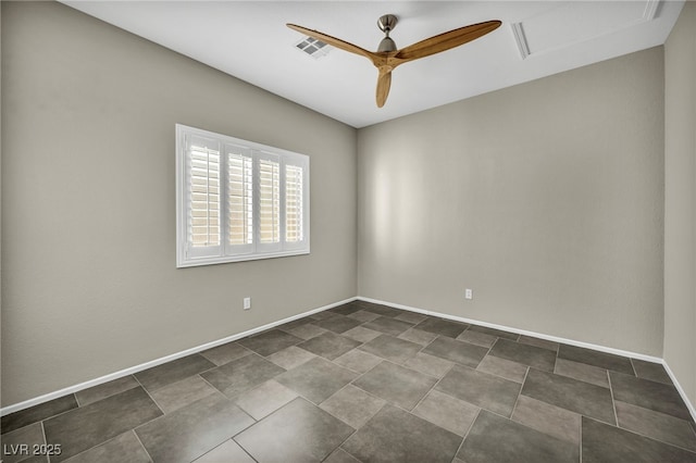 spare room featuring ceiling fan, visible vents, attic access, and baseboards