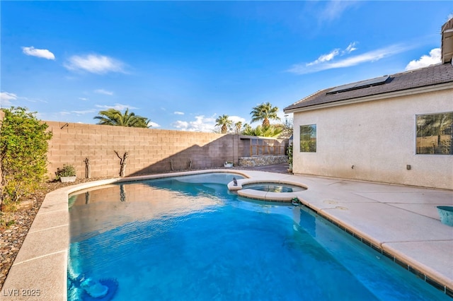 view of pool featuring a patio area, a fenced backyard, and a pool with connected hot tub