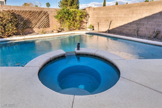 view of pool featuring a fenced backyard and a pool with connected hot tub