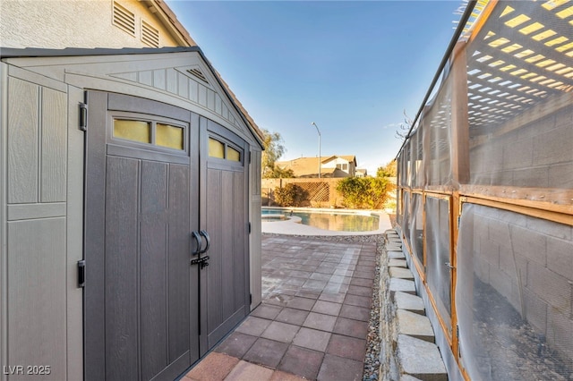 view of shed with a fenced backyard and a fenced in pool