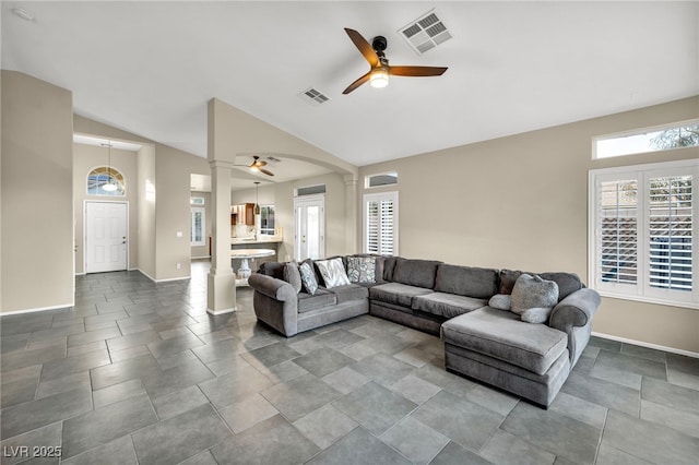 living room featuring lofted ceiling, plenty of natural light, visible vents, and ceiling fan