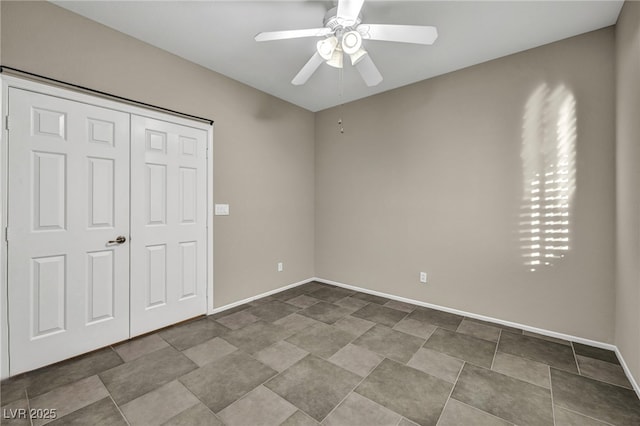 unfurnished bedroom featuring ceiling fan and baseboards