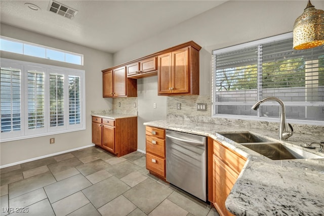 kitchen featuring brown cabinets, visible vents, a sink, light stone countertops, and dishwasher