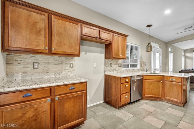 kitchen with visible vents, brown cabinets, a peninsula, pendant lighting, and stainless steel dishwasher