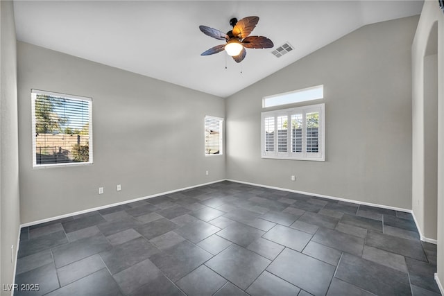 empty room with lofted ceiling, ceiling fan, visible vents, and baseboards