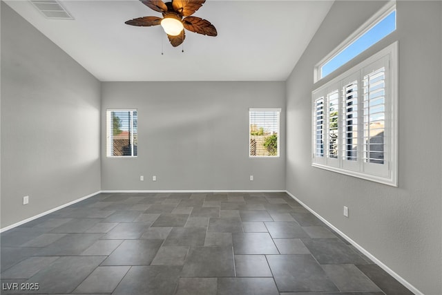 spare room with ceiling fan, plenty of natural light, visible vents, and baseboards