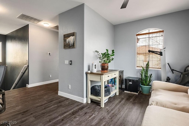 sitting room featuring ceiling fan, visible vents, baseboards, and wood finished floors