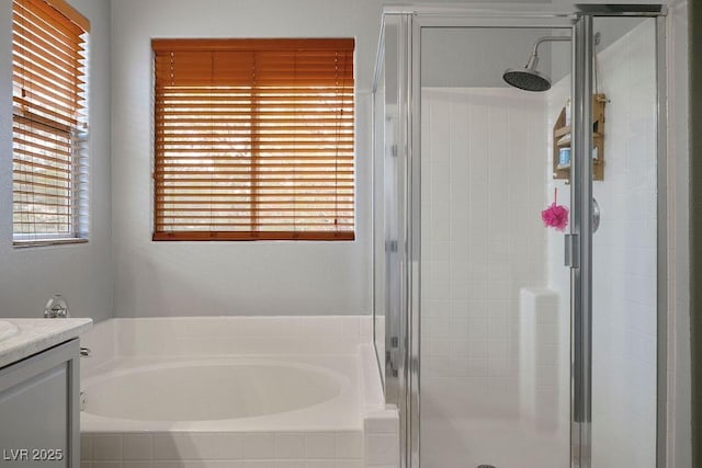 bathroom with vanity, a shower stall, and a bath