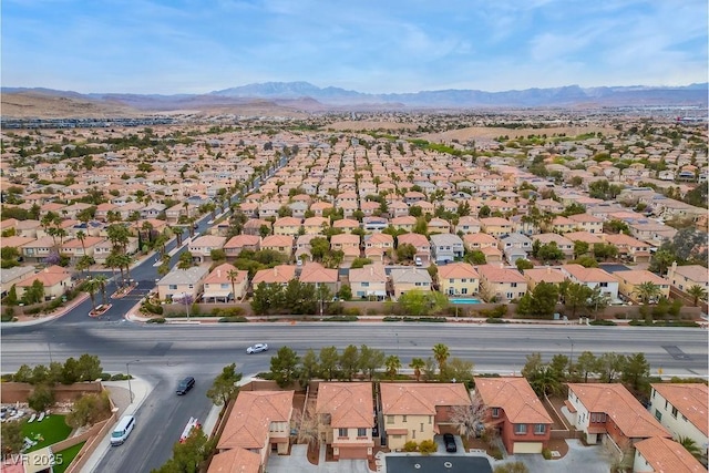 drone / aerial view featuring a residential view and a mountain view