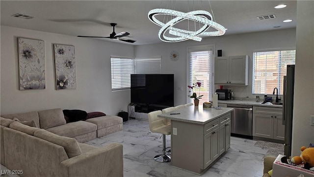 kitchen with marble finish floor, visible vents, open floor plan, and dishwasher