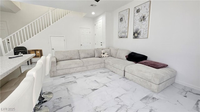 living area featuring baseboards, visible vents, stairway, marble finish floor, and recessed lighting