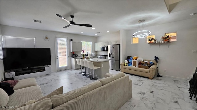 living room with ceiling fan, recessed lighting, visible vents, baseboards, and marble finish floor