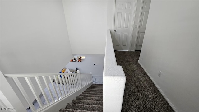 stairs with baseboards and carpet flooring