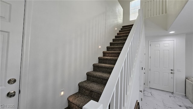 staircase with marble finish floor